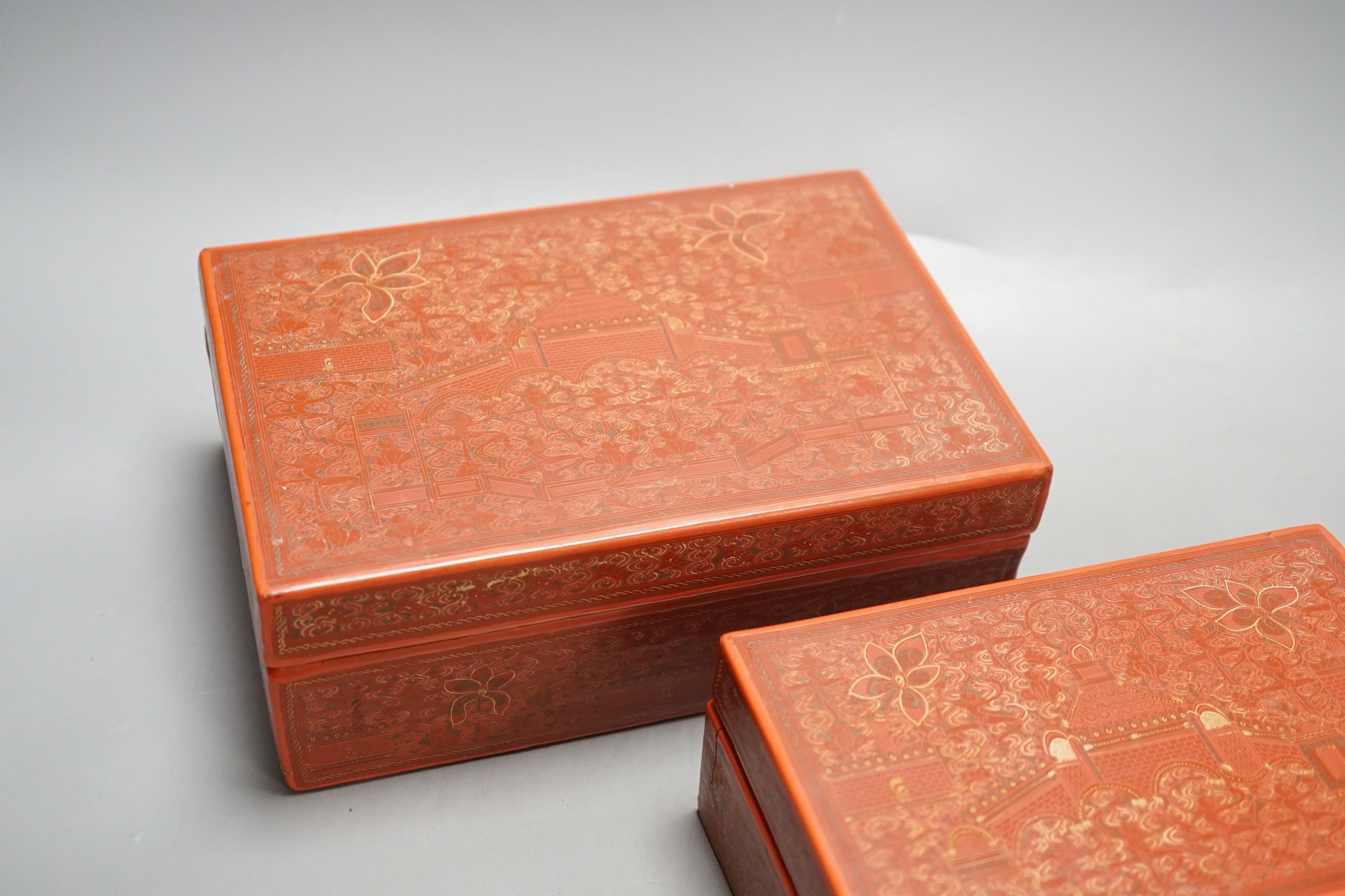 Three Burmese red lacquer graduated boxes, largest 21 cms wide.